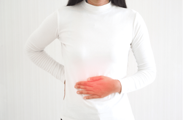gastroenteritis in asian woman and she touching her abdomen